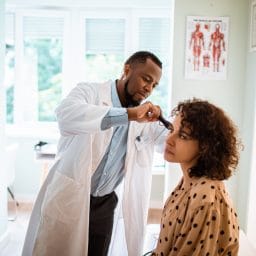 Close up of a doctor doing a medical exam on his patient