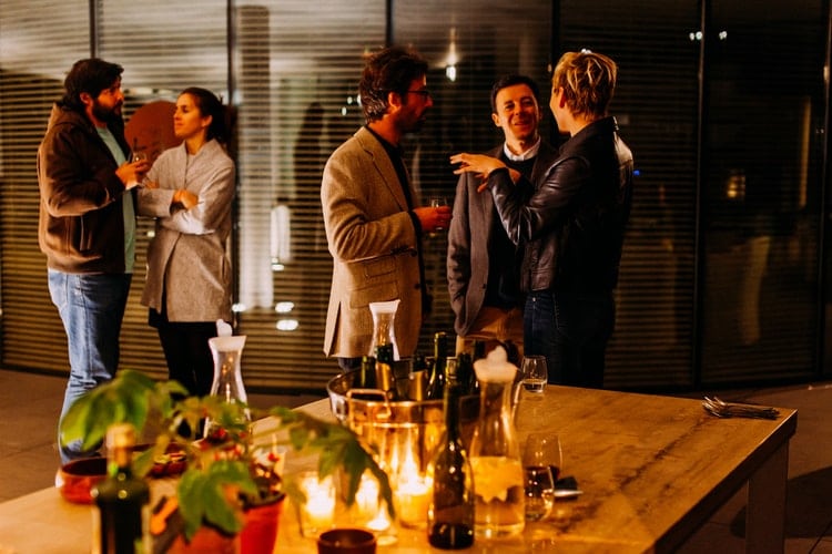 People talking at a holiday dinner party.