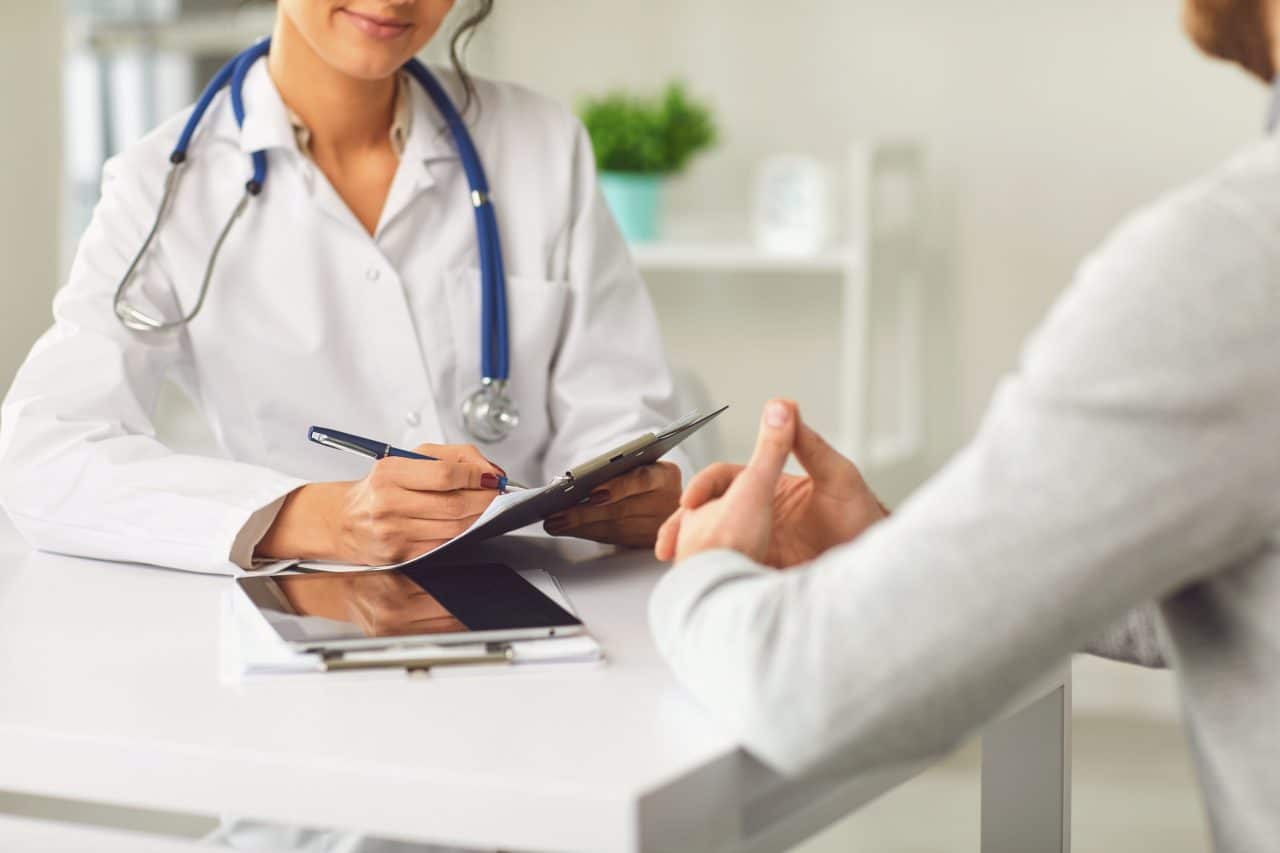 Doctor talking with a patient in a medical office.