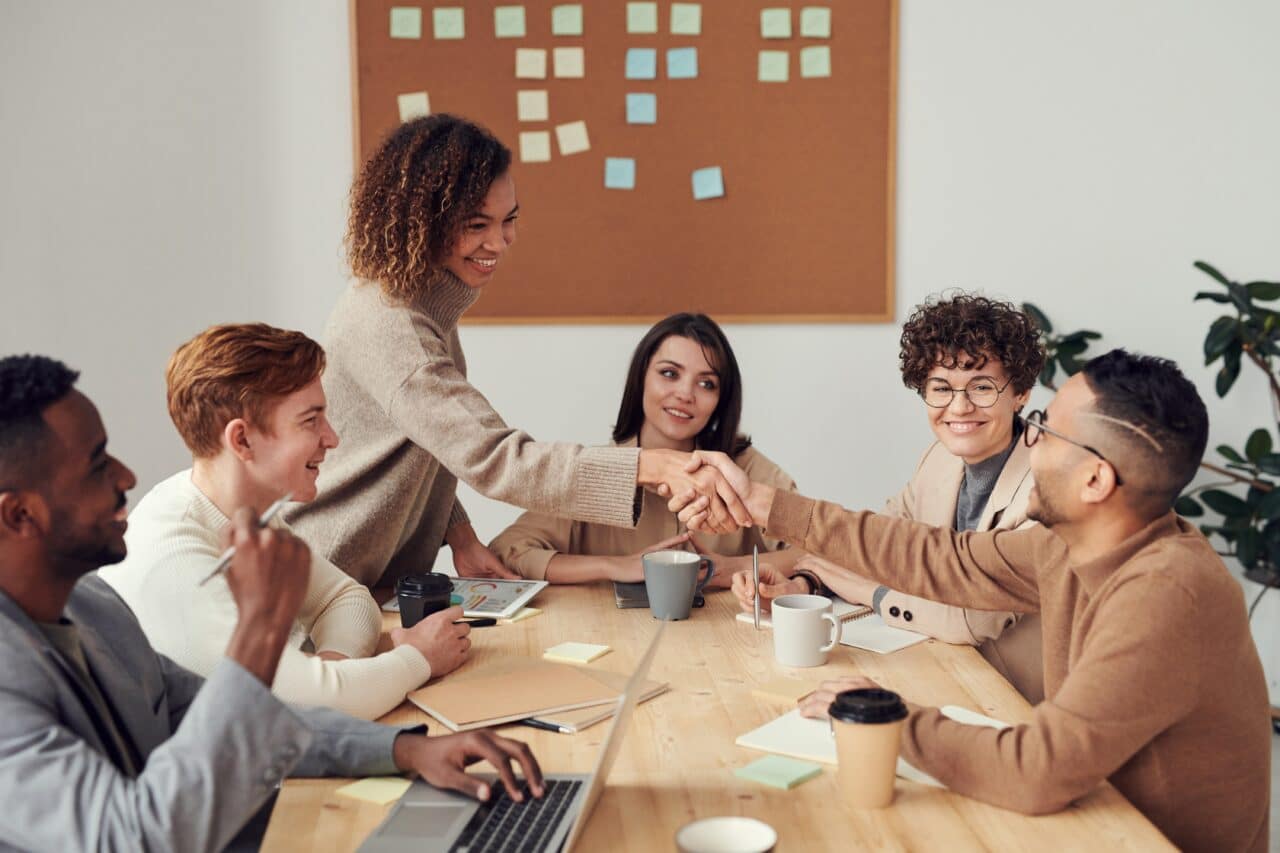 Woman shaking hands with her colleague during a business meeting.