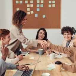 Woman shaking hands with her colleague during a business meeting.