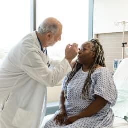 Doctor examining a woman for signs of a concussion