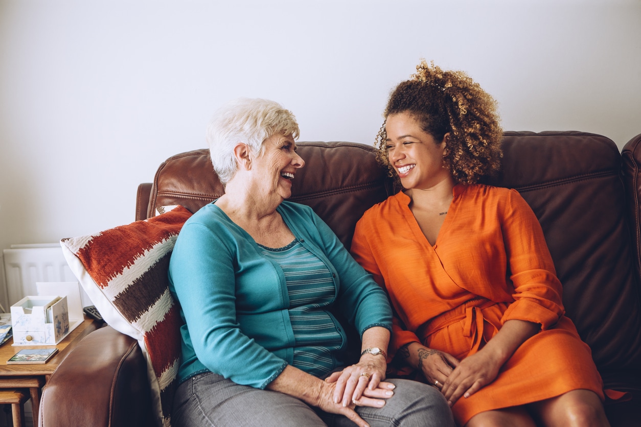 Young woman laughing with her grandma.