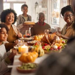 Happy extended family having a meal on Thanksgiving at home